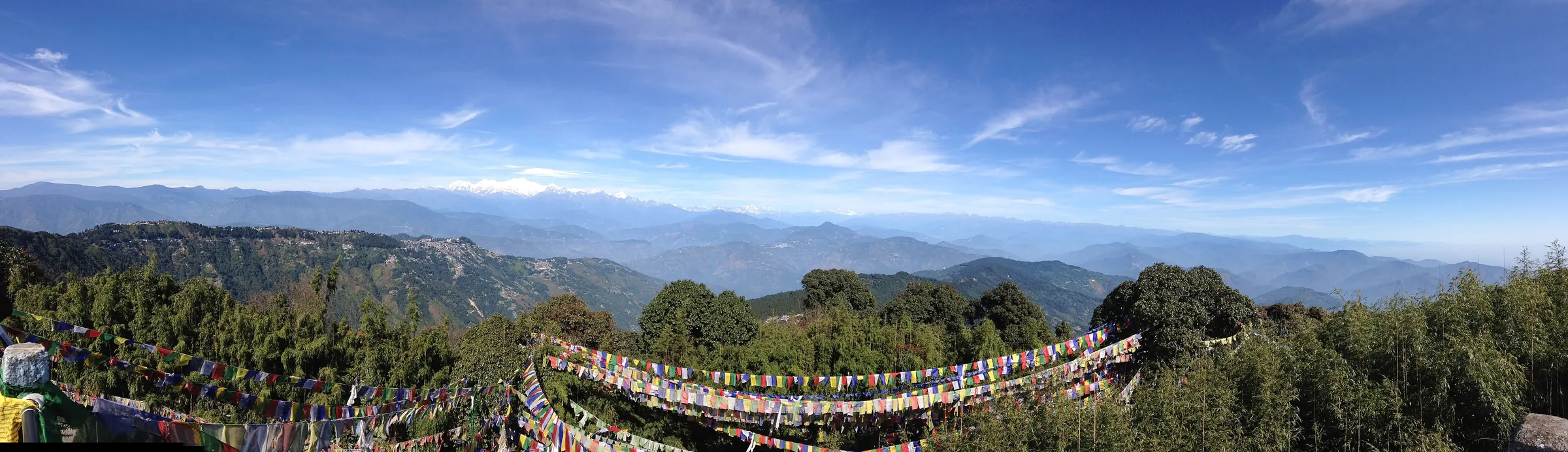 Panorama from Tiger Hill over the Darjeeling hills to the snow peaks, with prayer flags